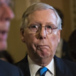 Senate Majority Leader Mitch McConnell, R-Ky., listens to remarks by Sen. John Barrasso, R-Wyo., as they meet with reporters after a closed-door Republican strategy session, on Capitol Hill in Washington, Tuesday, July 11, 2017. McConnell says Senate Republicans will unveil their revised health care bill Thursday and begin voting on it next week, adding, he could delay the chamber's August recess for two weeks as the GOP tries breaking logjams that have slowed work on that and other issues. (AP Photo/J. Scott Applewhite)