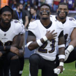 Baltimore Ravens strong safety Tony Jefferson (23) and Baltimore Ravens outside linebacker Matt Judon, left, kneel down with teammates during the playing of the U.S. national anthem before an NFL football game against the Jacksonville Jaguars at Wembley Stadium in London, Sunday Sept. 24, 2017. (AP Photo/Matt Dunham)