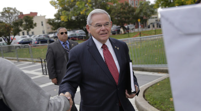 New Jersey Senator Robert Menendez greets supporters as he arrives to court in Newark N.J. Monday Oct. 16 2017. The judge in Menendez's corruption trial could rule on Monday to dismiss the bulk of the indictment against the New Jersey Democrat
