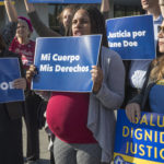 Activists with Planned Parenthood demonstrate in support of "Jane Doe," a pregnant 17-year-old being held in a Texas facility for unaccompanied immigrant children to obtain an abortion, outside of the Department of Health and Human Services in Washington, Friday, Oct. 20, 2017. (AP Photo/J. Scott Applewhite)