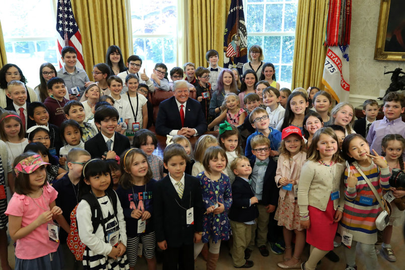 WASHINGTON, DC - APRIL 26: U.S. President Donald Trump is surrounded by the children of members of the media during Take Your Child To Work Day in the Oval Office on April 26, 2018 in Washington, DC. (Photo by Mark Wilson/Getty Images)